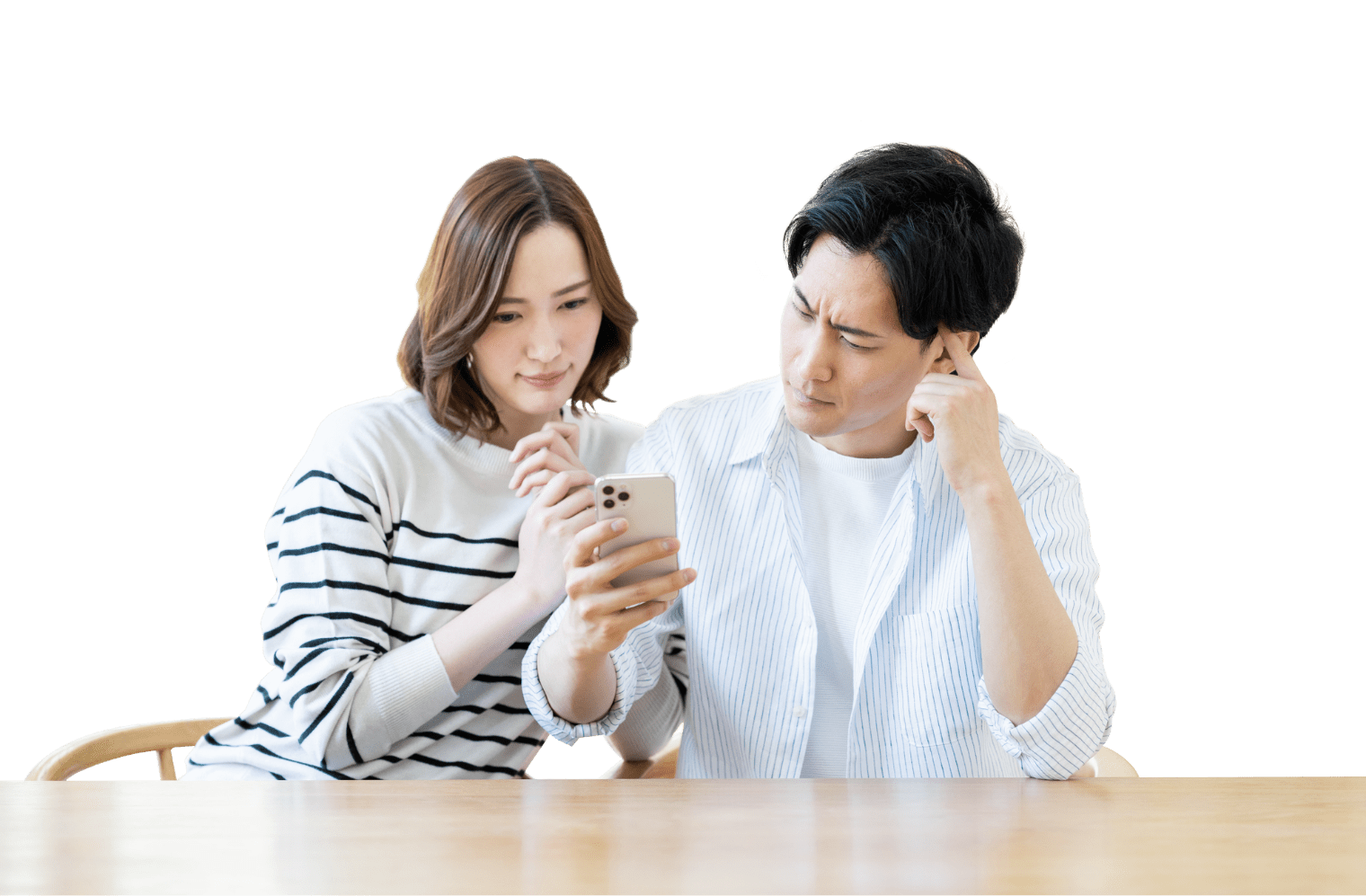 夫婦がスマホの画面を見て苦渋に満ちた顔をしている画像